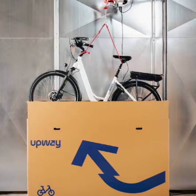 Electric bike lifted into shipping box