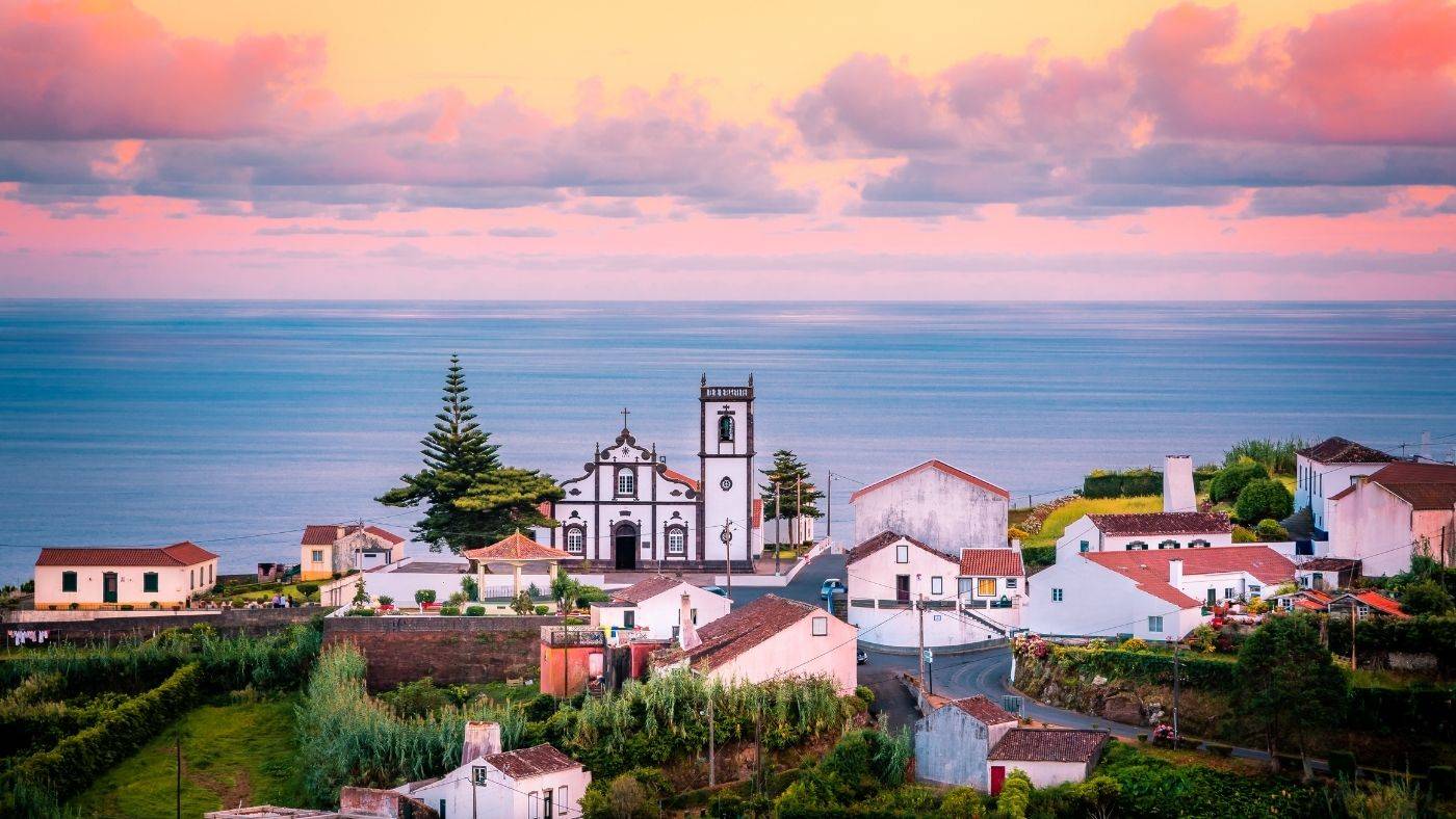 Azores Portugal Travel Guide Church and Houses Overlooking the Ocean and Sunset