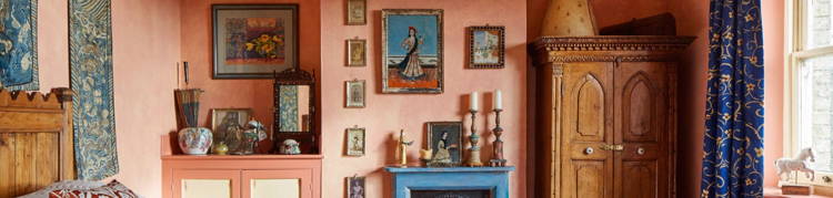 A bedroom interior filled with antique Indian furniture & antiques