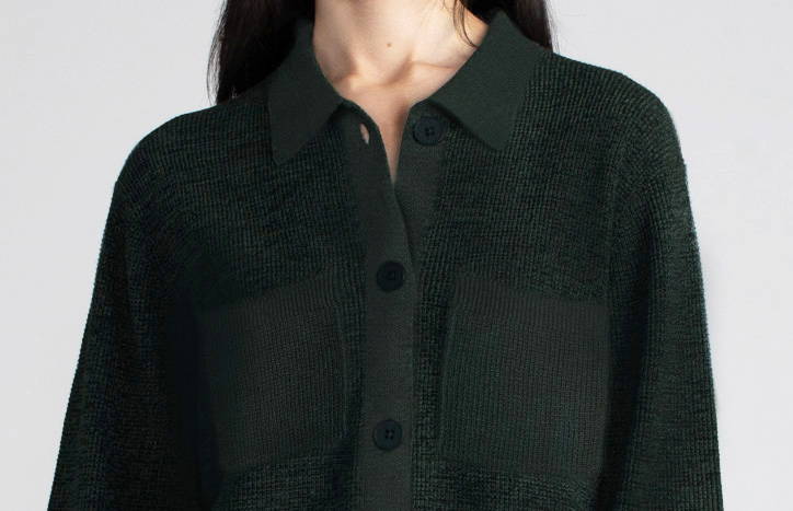 Close up of woman wearing a dark green waffle shacket.