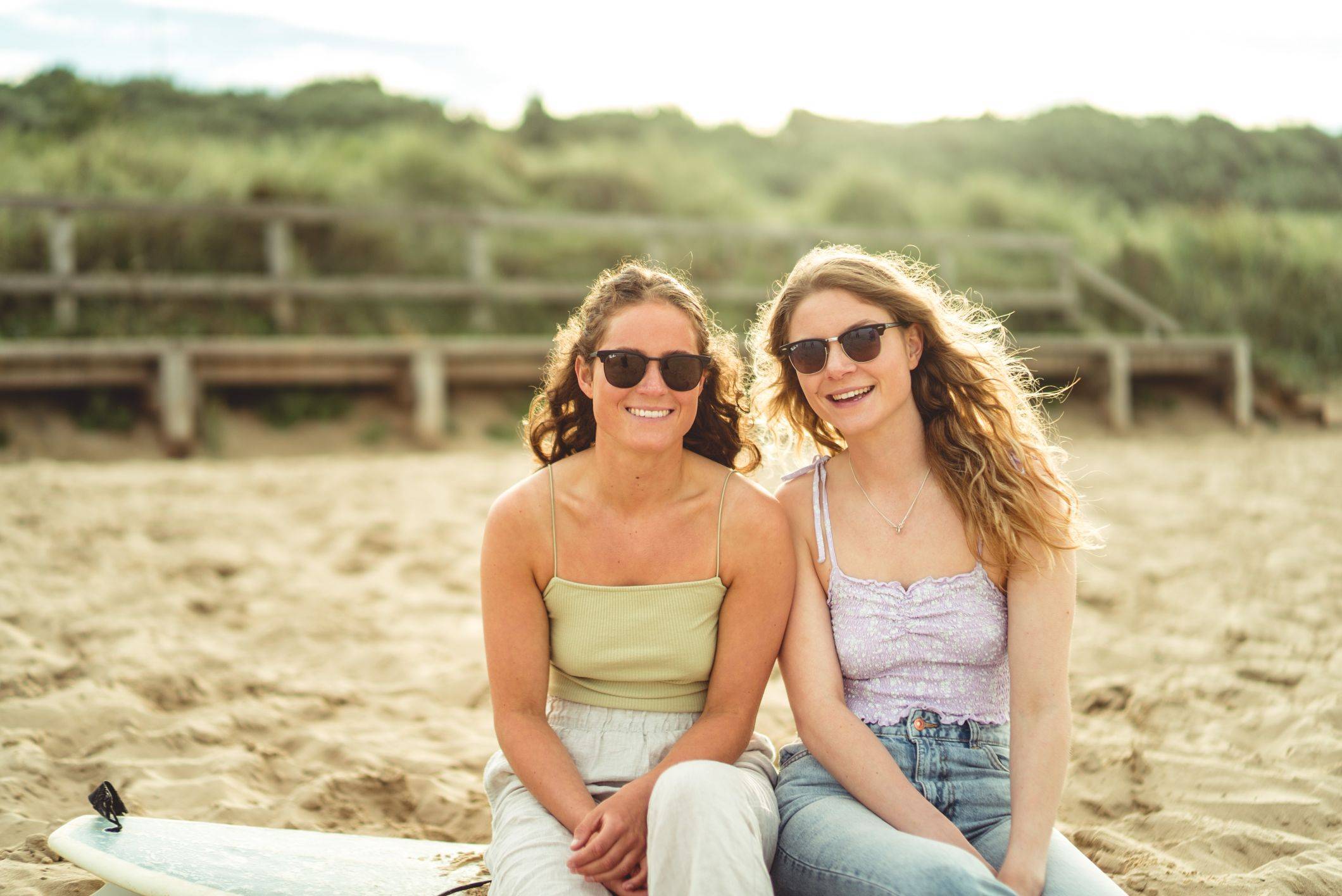 girls with wavy hair smiling on beach