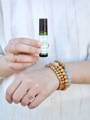 woman holding essential oil roller bottle 