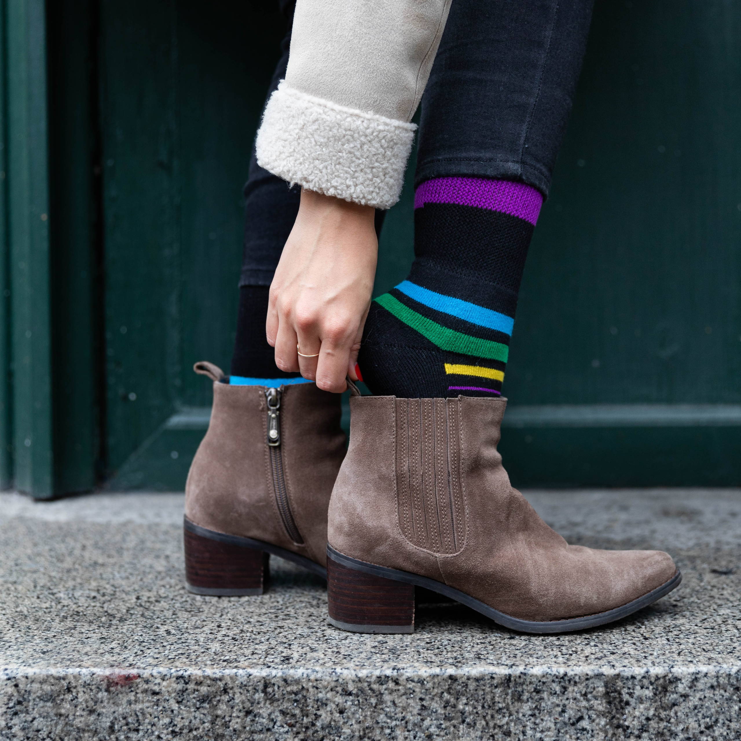 Close up image of person standing and putting on shoe. Wearing Dr. Segal's diabetic socks.