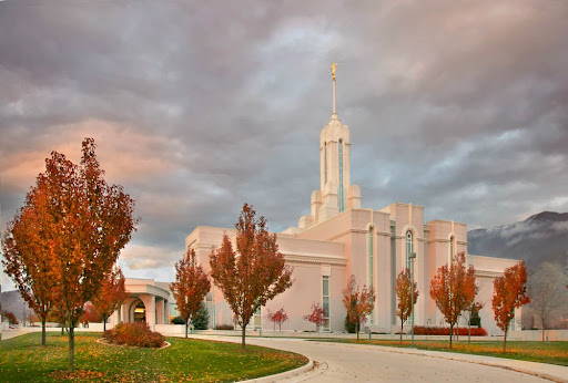 Mt Timpanogos temple surrounded by orange trees.