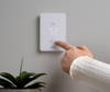 Wall mounted Mysa for Electric Baseboard Heaters V2 next to mobile phone displaying app - both displaying temperature