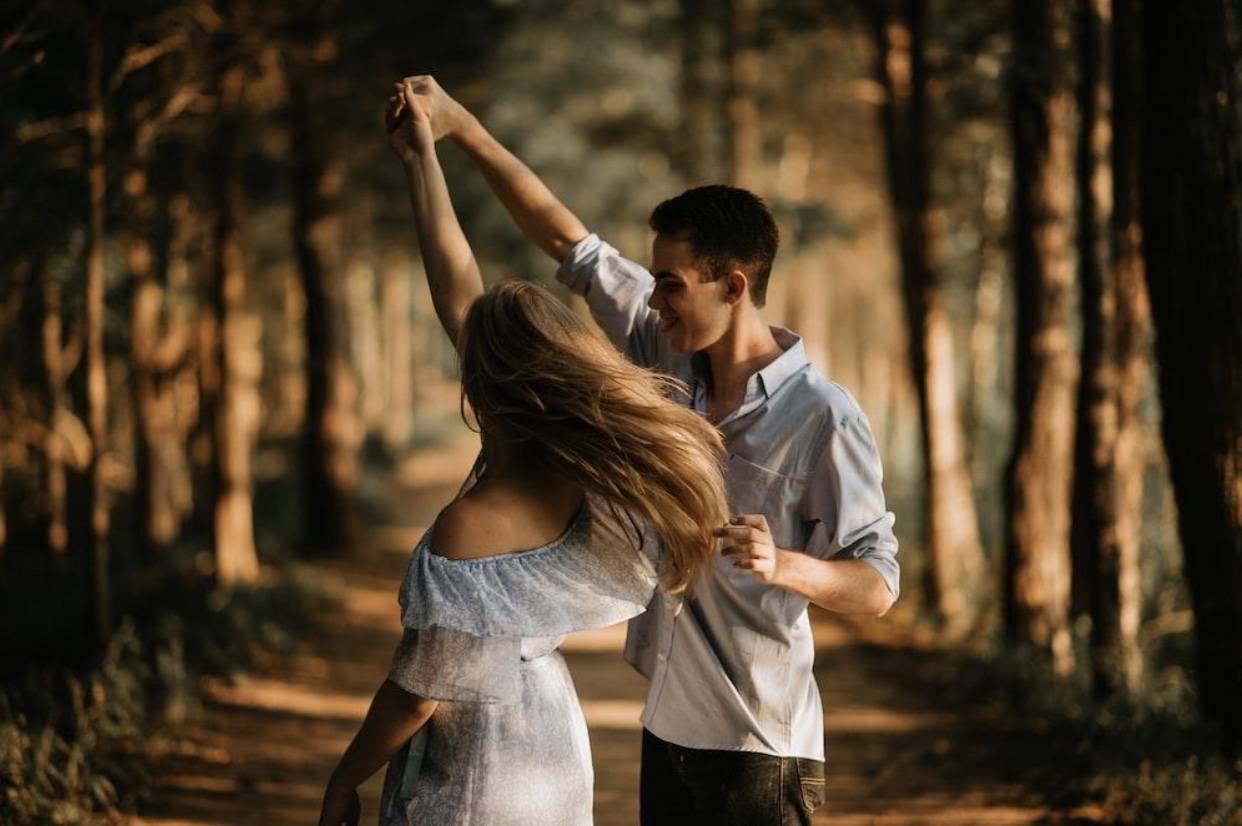 young couple dancing outside 