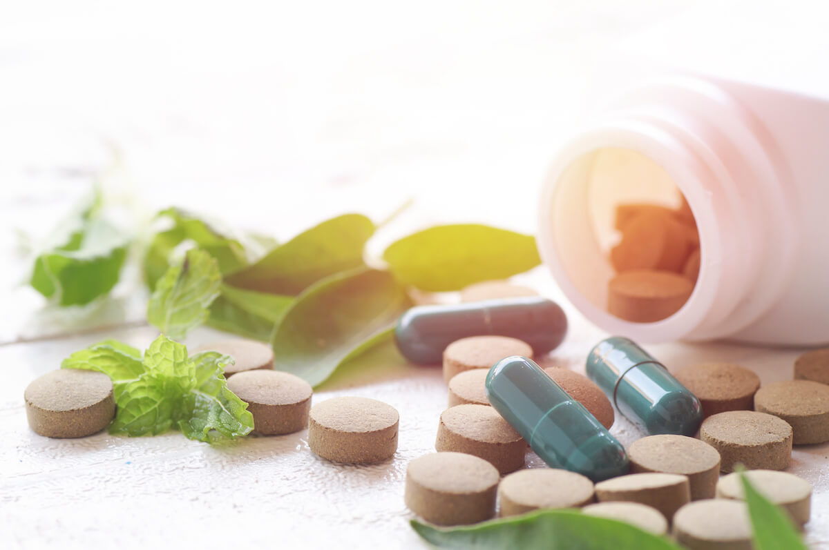 Pills and herbs on a table