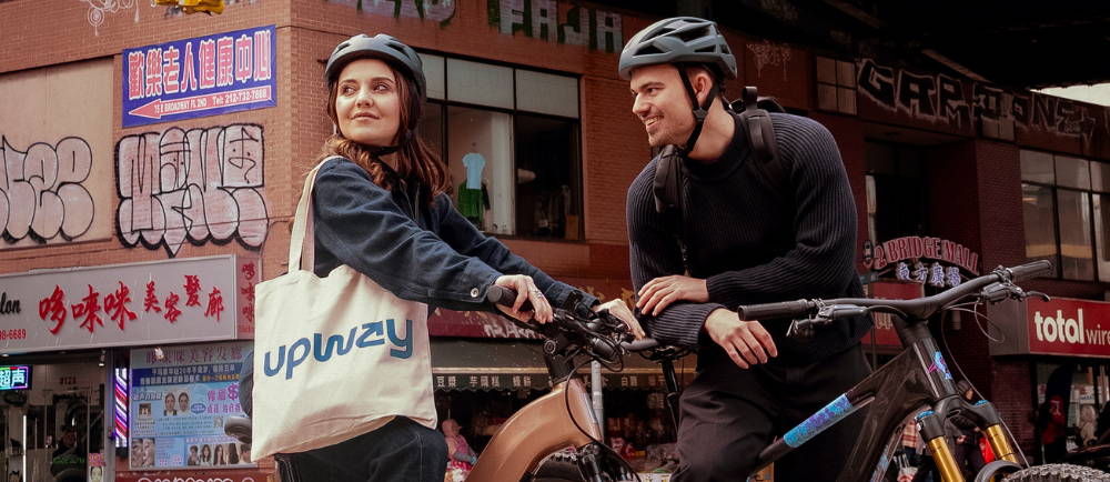 man and woman on electric bikes in the city