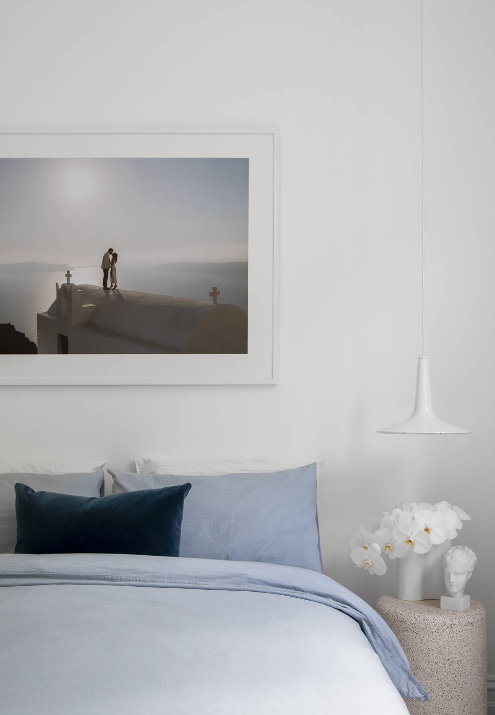 Wedding photography framed and hanging above a bed