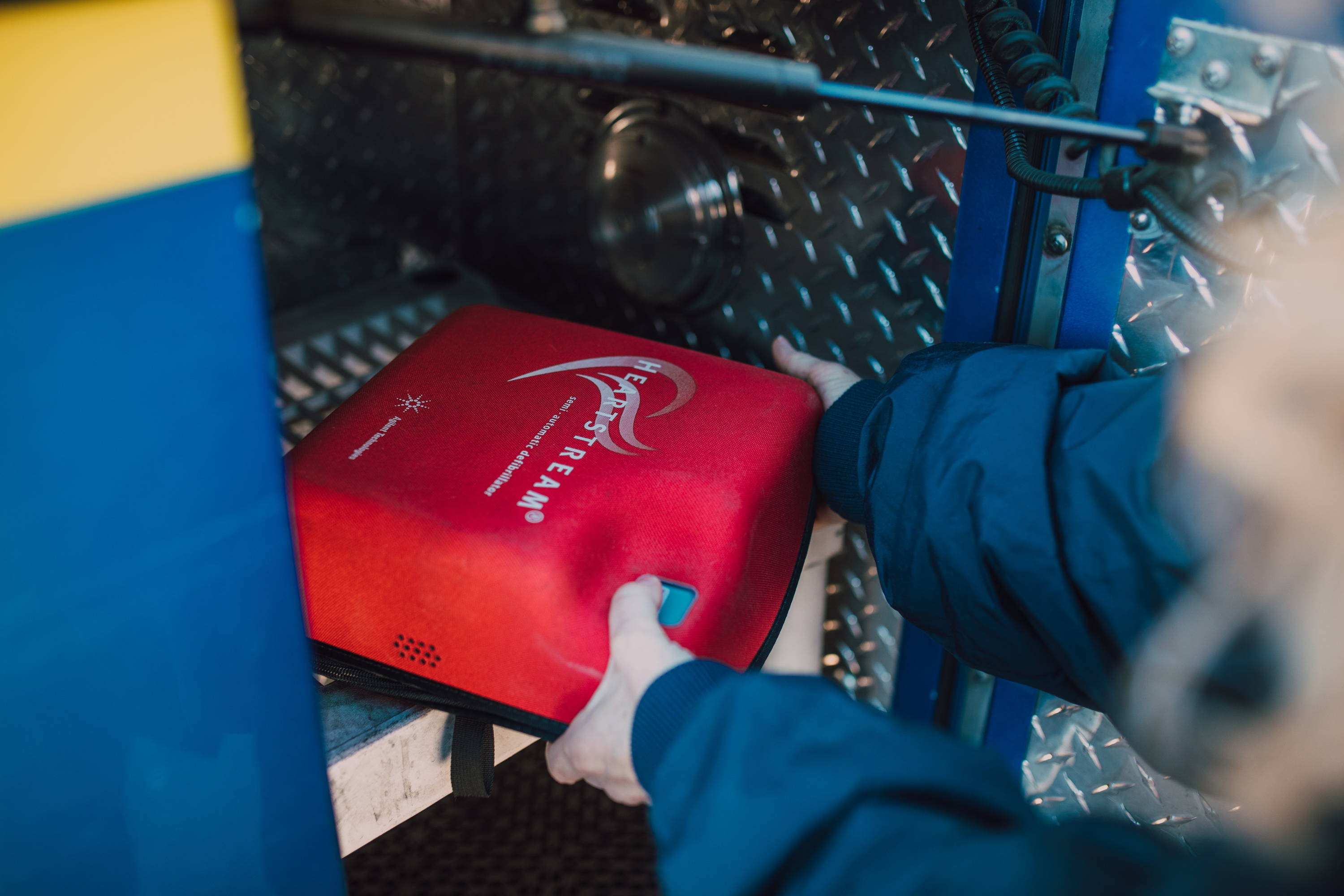 Automated External Defibrillator being retrieved from storage