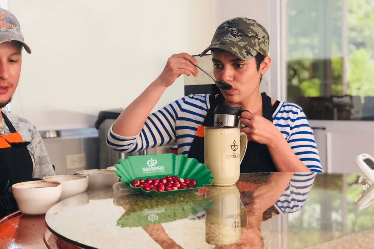 Woman tasting and cupping coffee