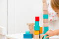 Toddler playing with Montessori wooden shape blocks. 
