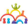 Colorful pieces of a Montessori wooden rainbow toy with pegs and arches. 