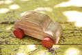 Wooden car toy with wheels.