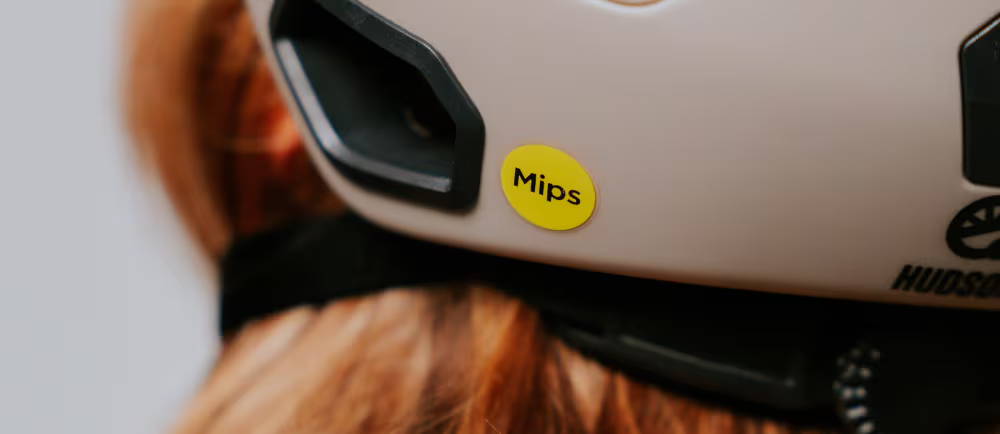 Closeup of MIPS yellow sticker on bicycle helmet