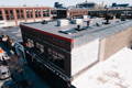 rooftop of the frost river shop with 2 construction workers putting in the first row of solar panels