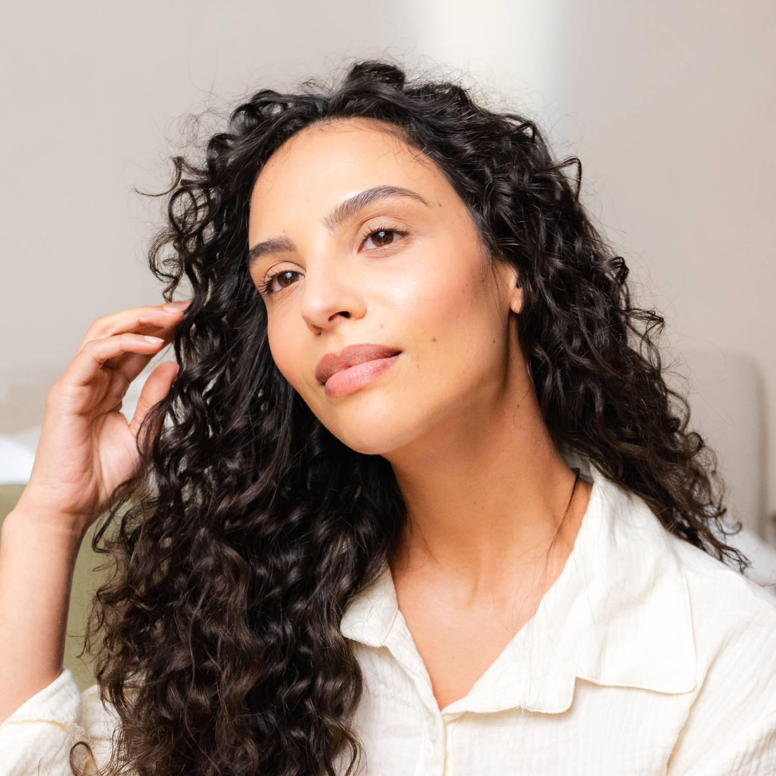 Davines hair model with long, dark curls