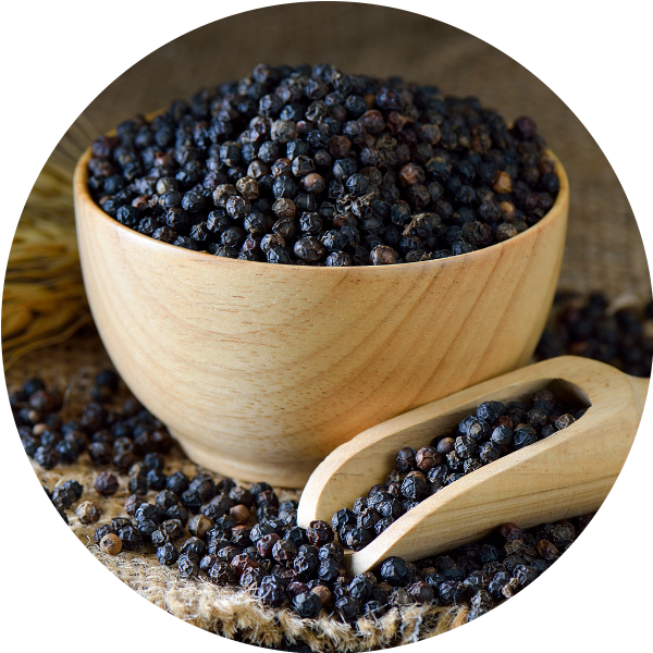 Black peppercorns in a wooden bowl — known to boost nutrient absorption and improve the effectiveness of a milk thistle supplement.
