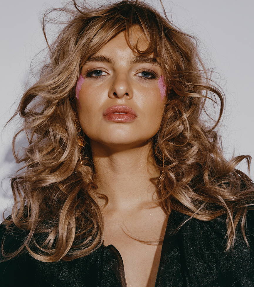 Davines hair model with big, loose curls