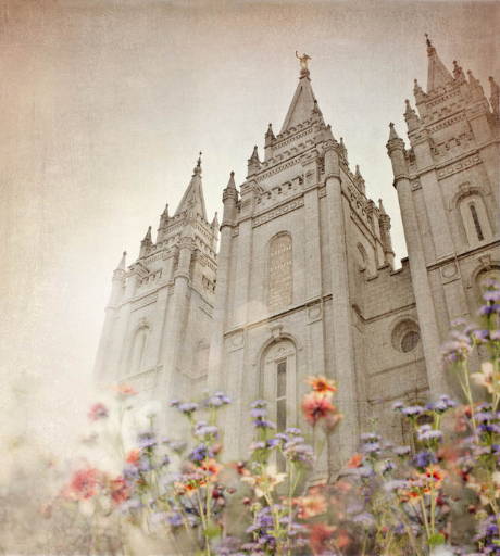 Faded Salt Lake Temple picture with with orange and blue flowers in the front. 
