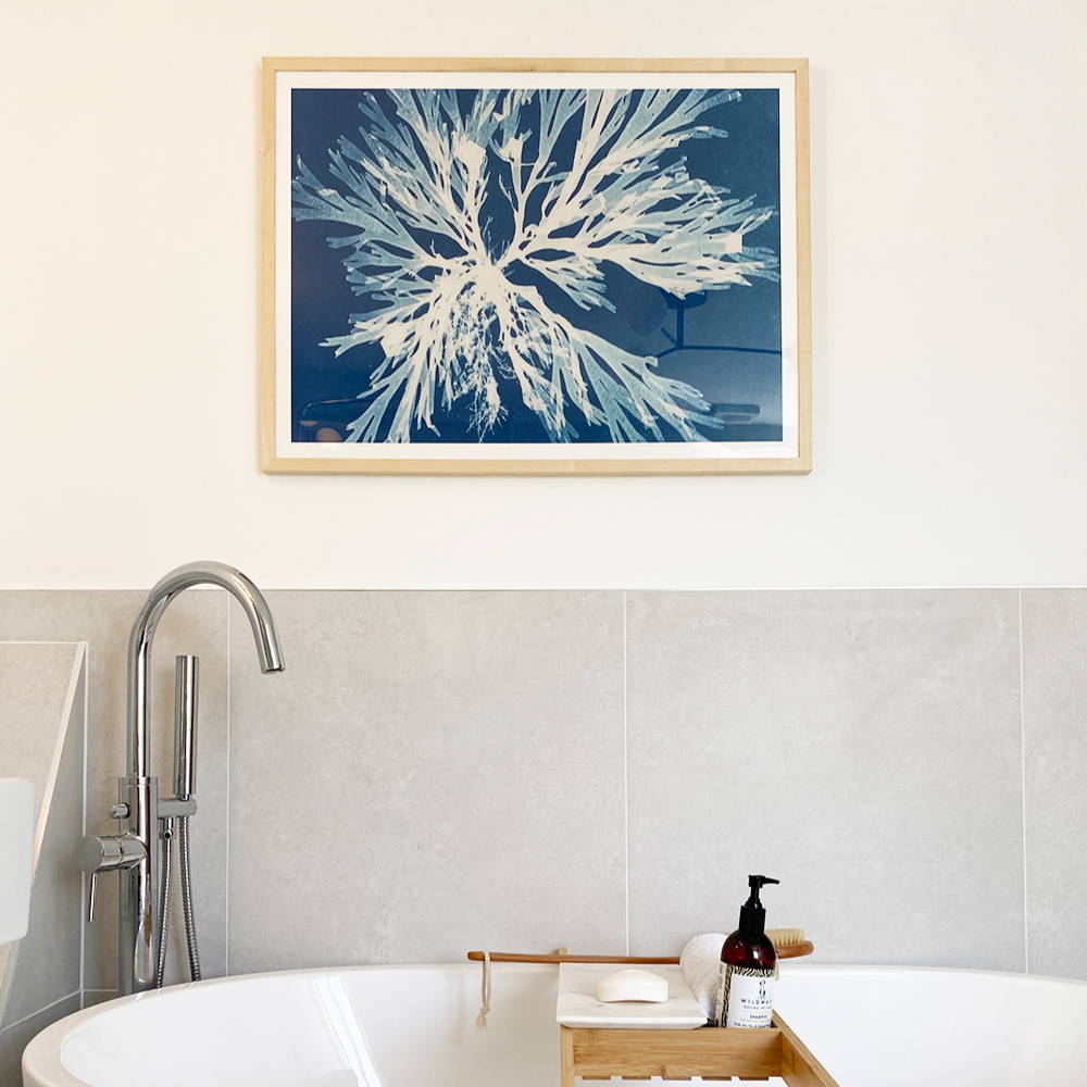 Cyan seaweed art print in bathroom above bath