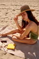 woman applying sunscreen on the beach