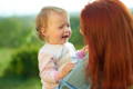 Parent comforting a crying toddler outdoors, providing calm support and co-regulation.