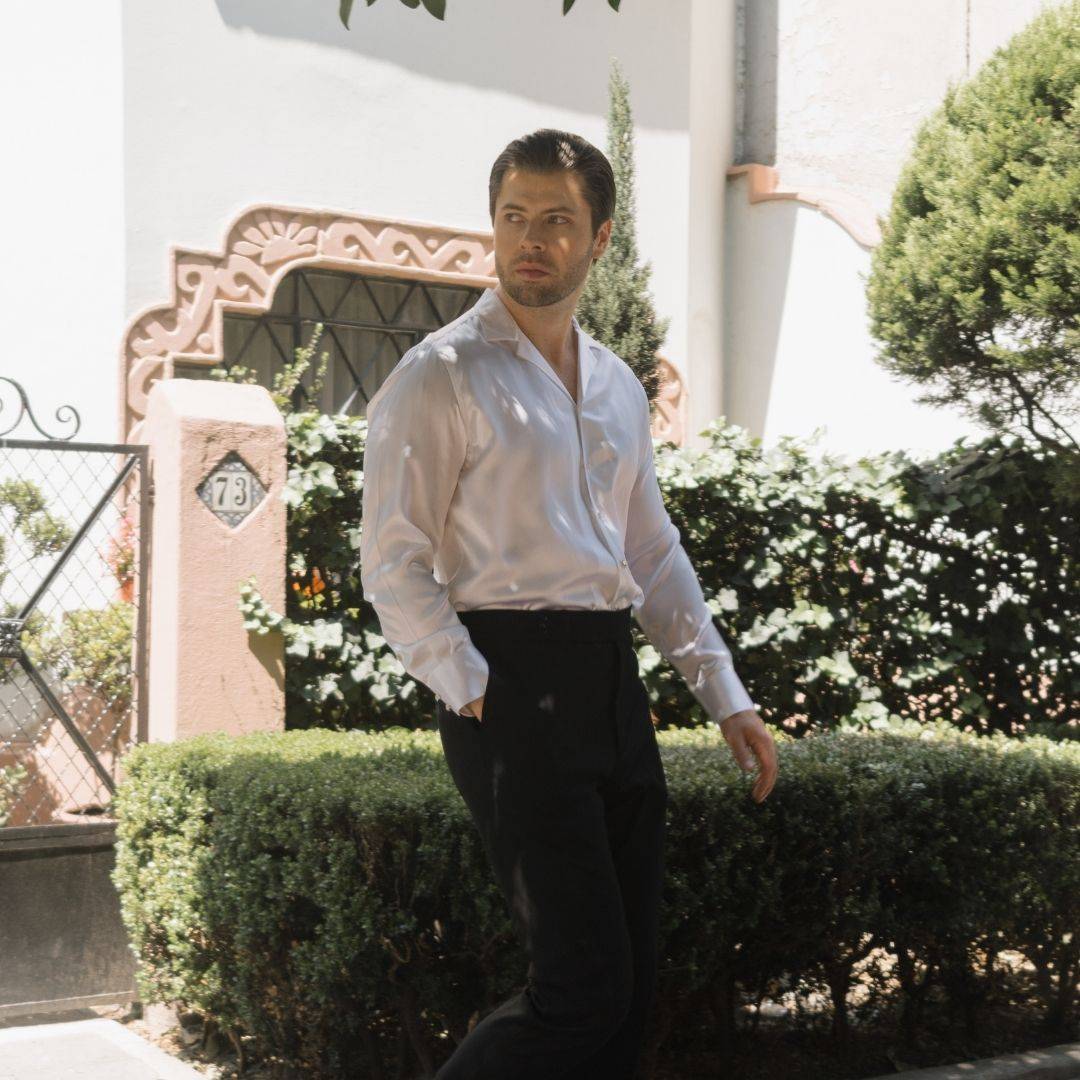 model walking on the street wearing black pants and a long sleeve white silk shirt from 1000 kingdoms