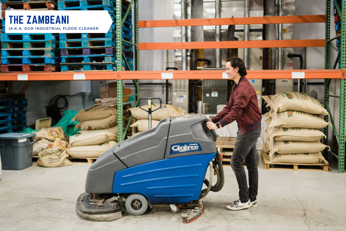 A man operating the industrial cleaning machine. 