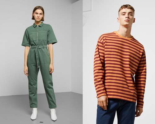 Woman wearing organic cotton khaki green jumpsuit with white ankle boots and man wearing orange and burgundy striped oversized long sleeve t-shirt with blue indigo jeans from sustainable fashion brand Weekday