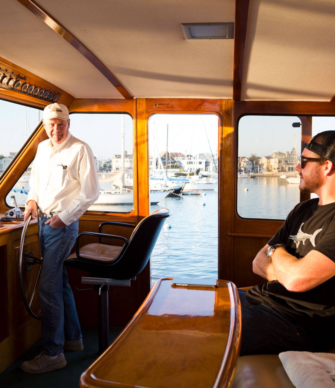 Owner Thos Carson and His Father inside of the boat talking. 