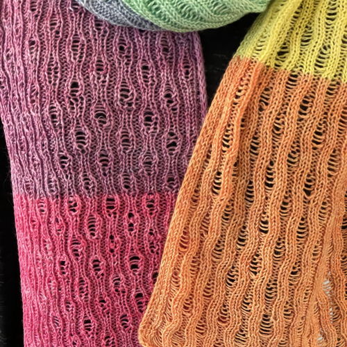 Knitted scarf Yvonne with dropped stitches and i-cord edge.