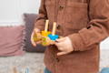 A boy playing with wooden Montessori train stacker toy.