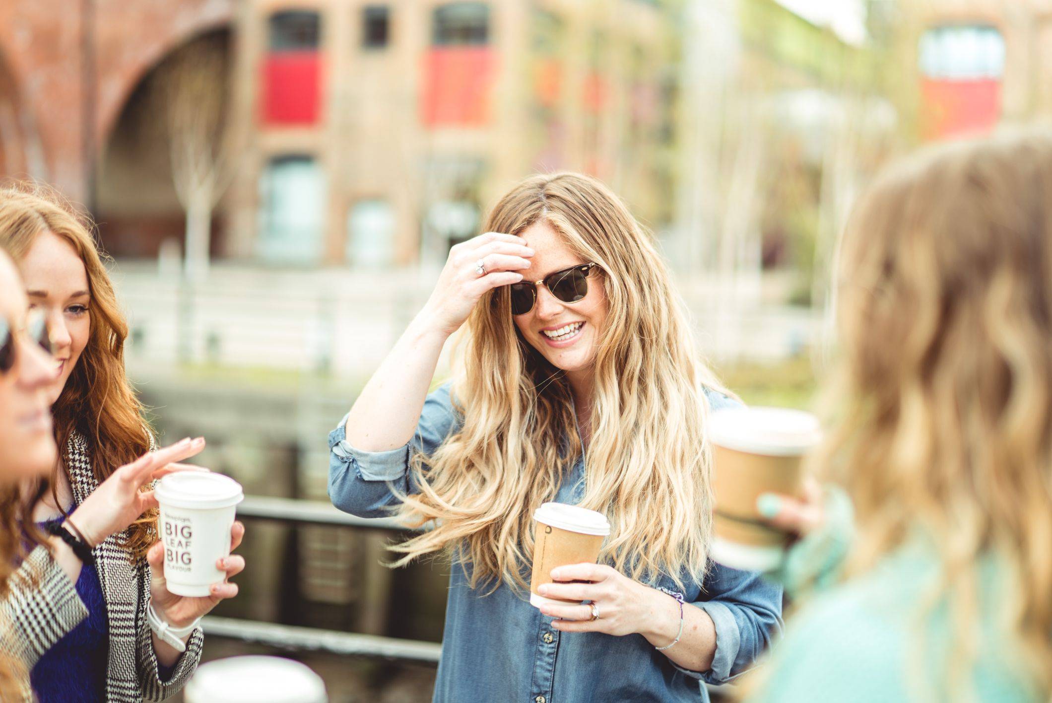 Image of two girls drinking coffee in the sun