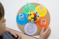 Boy playing with colorful Montessori pom poms.