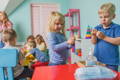 Children using hand sanitizer in the playroom before playtime.