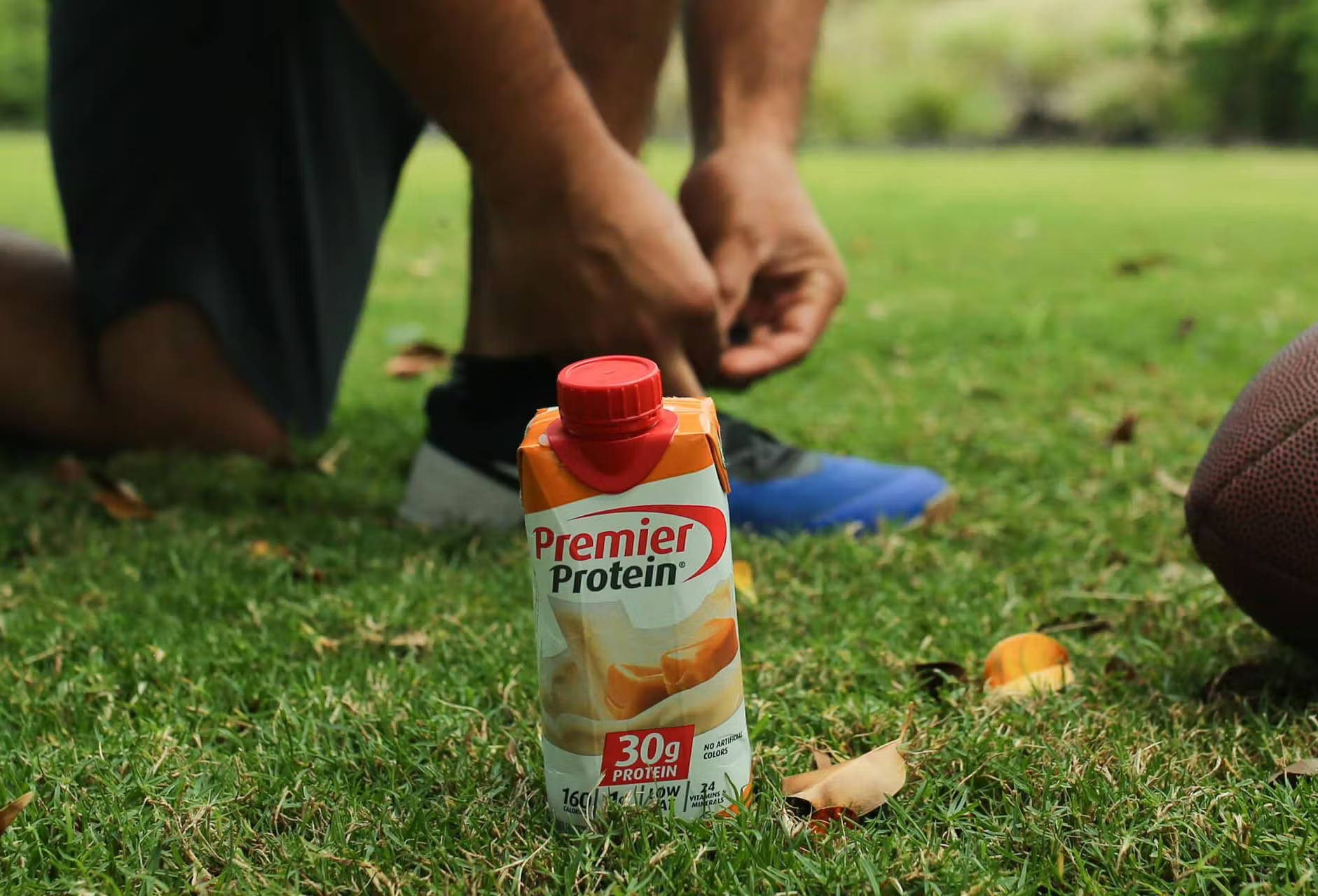 athlete and the bottle of premiere protein