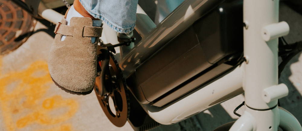 a woman in birkinstocks riding a specialized Globe Haul electric cargo bike