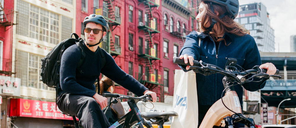 Two electric bike riders in NYC Chinatown
