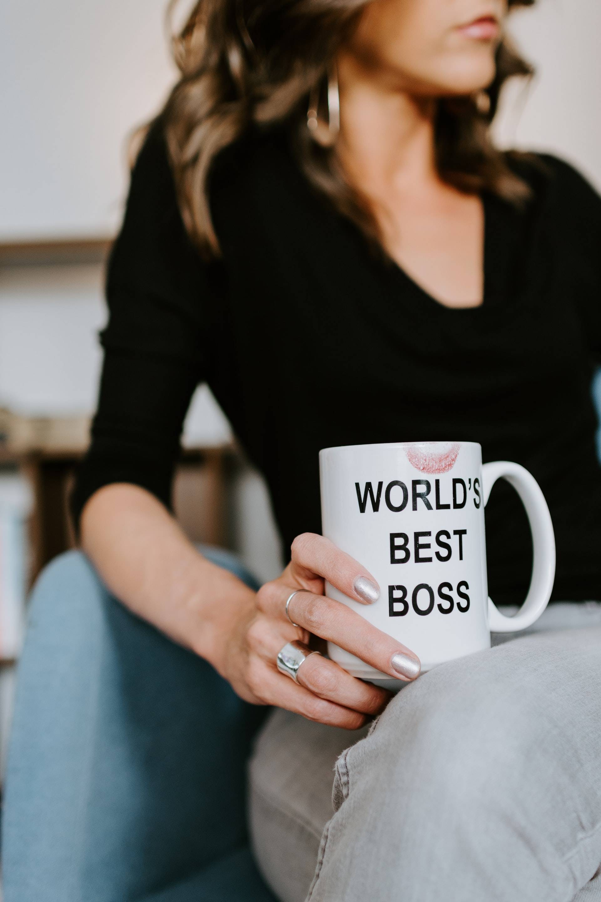 Woman holding a mug with "world's best boss" written on