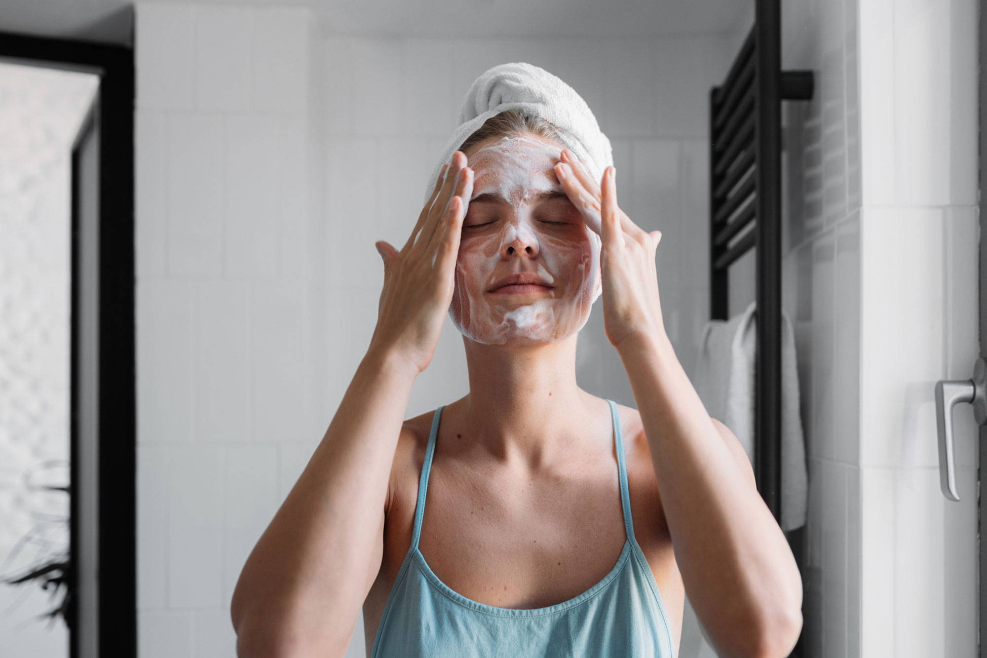 woman cleansing her face