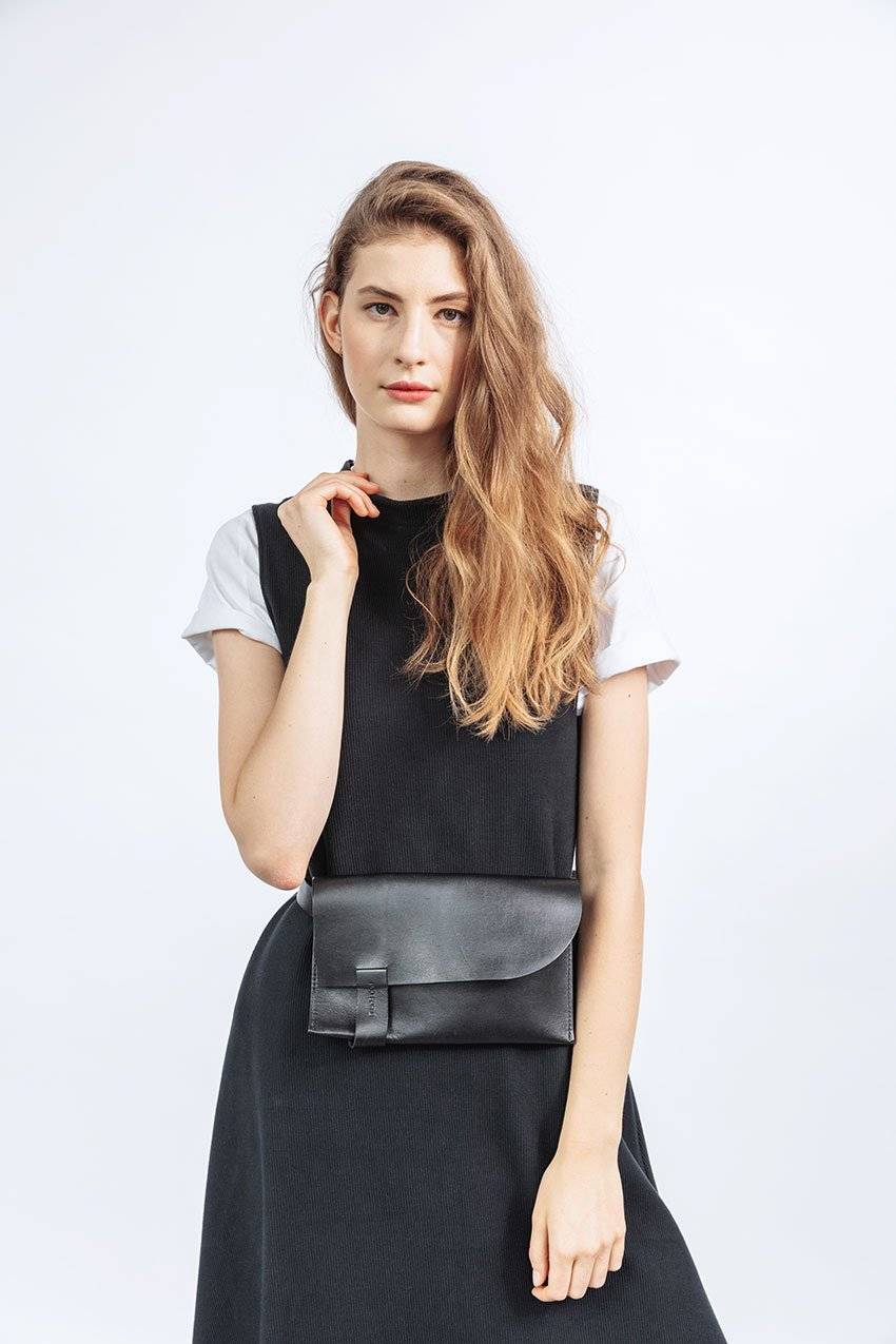 Close up of woman wearing black organic cotton dress with t-shirt