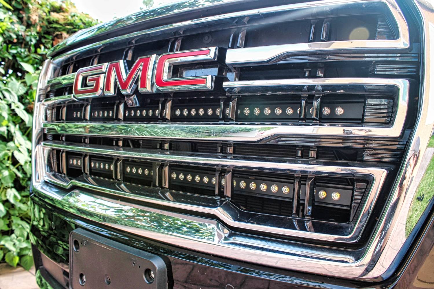 2023 gmc yukon with two 40in light bars behind the grille  by mandr automotive