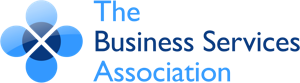 Logo of The Business Services Association. Features a blue, stylized four-petal flower design on the left, with the organizations name in blue text on the right.