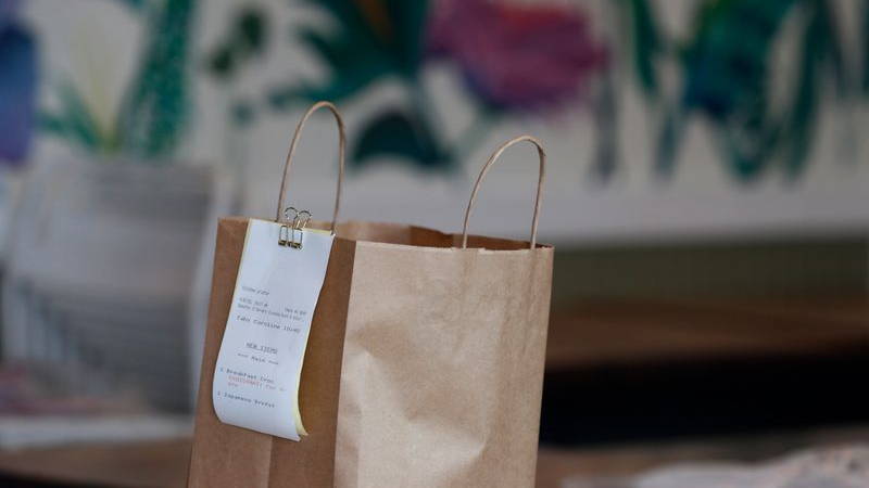 A takeout shopping bag and receipt.