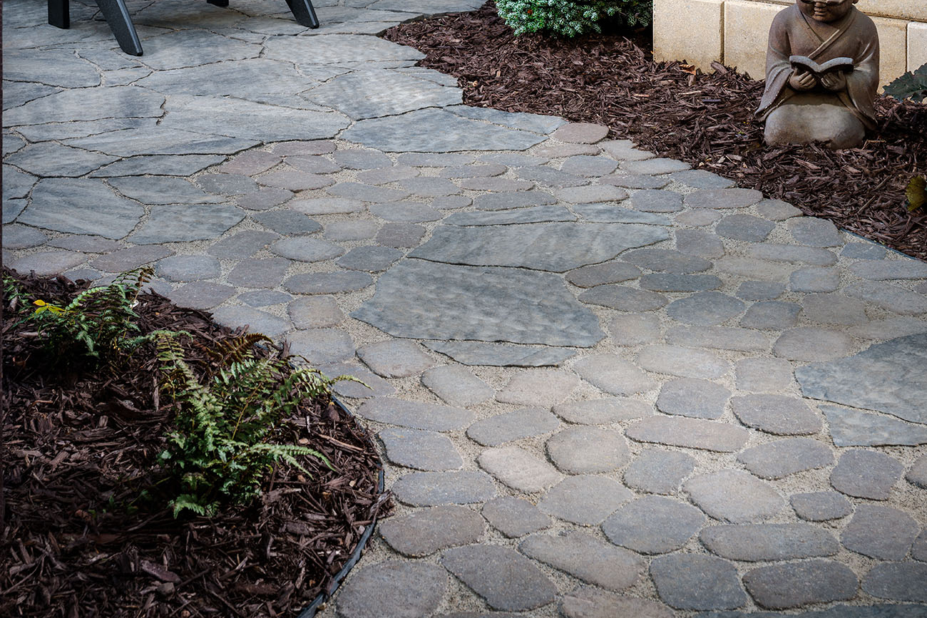 Driveway leading to a house build with pavers