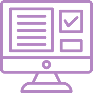 A person sitting at a desk, working on a laptop with charts and graphs displayed on the screen.