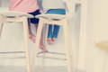 Kids sitting on a bar stool.