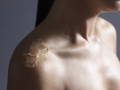 woman's shoulder with a body scrub applied onto the skin