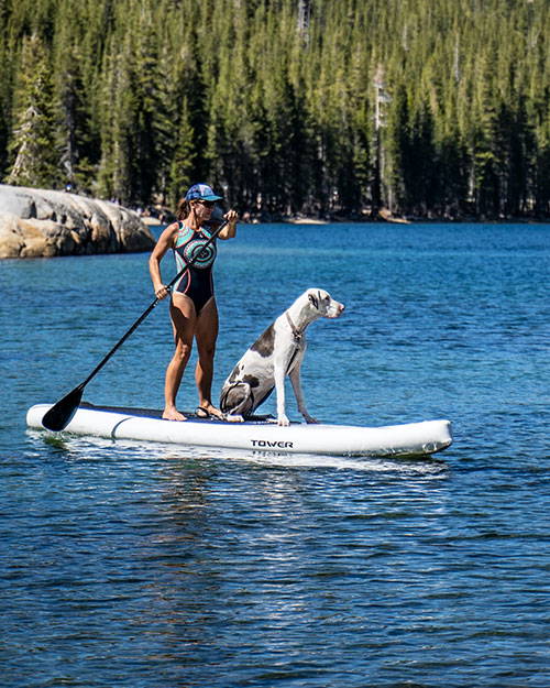Woman SUPing with her big dog